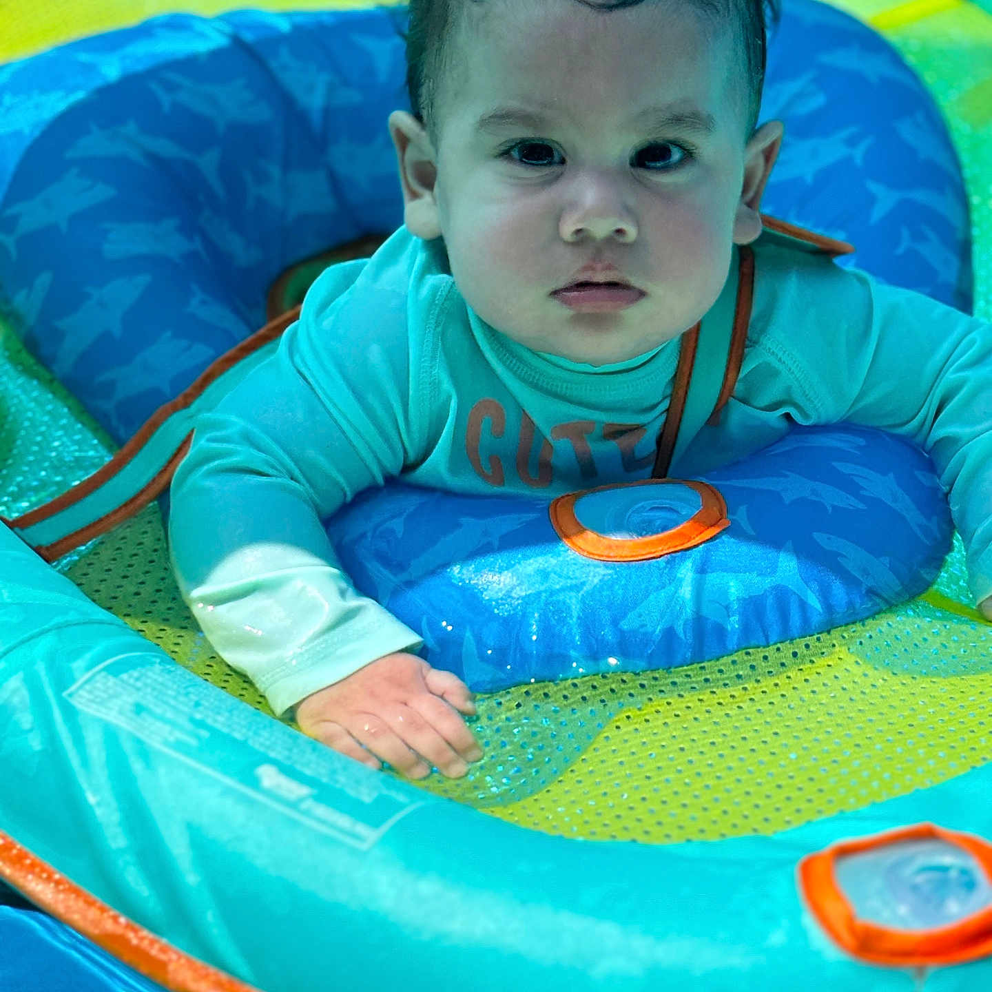 Romeo is registered to the contest to win money with this photo: amusementpark, baby, clothing, face, head, inflatable, lifejacket, outdoors, person, photography, playarea, pool, portrait, summer, t_shirt, toy, tubing, vest, water, waterpark