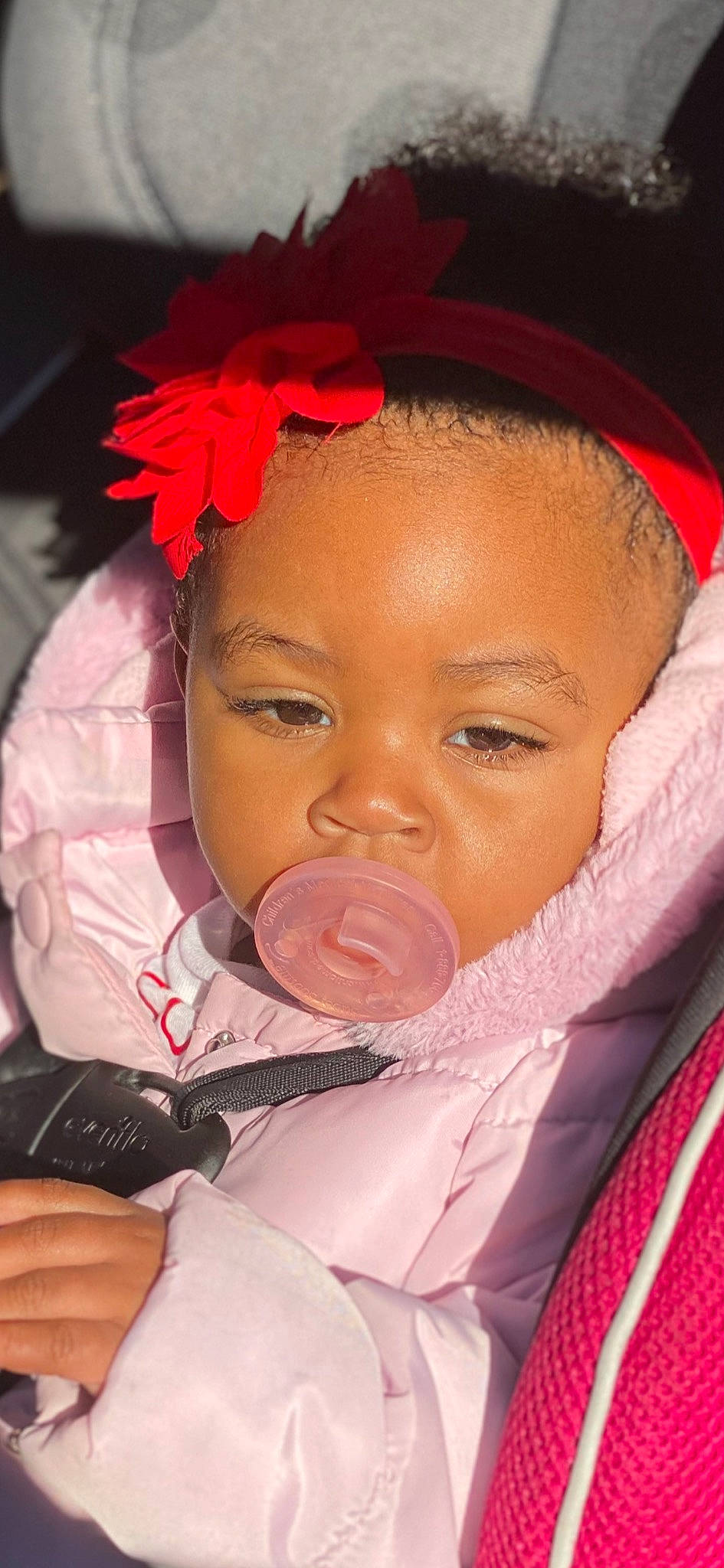 Nola is registered to the contest to win money with this photo: baby, baby_products, cheek, child, chin, close_up, face, forehead, hair_accessory, head, headband, headgear, lip, mouth, neck, nose, person, pink, skin, toddler