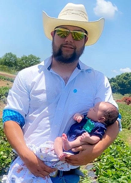 Dallas is registered to the contest to win money with this photo: arm, baby, beard, blue, eyewear, face, gesture, goggles, grass, grass_family, hand, happy, hat, headwear, joy, leisure, people_in_nature, person, plant, sky