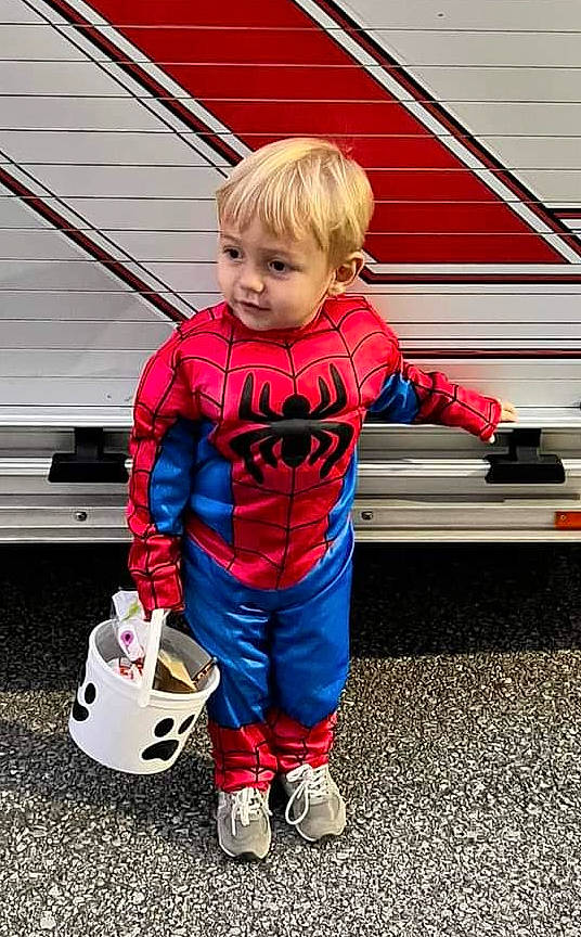 Graeson joined the competition — help win amazing prizes! automotive_exterior, automotive_wheel_system, bumper, car, child, cool, electric_blue, flooring, fun, leg, person, recreation, red, shoe, sneakers, standing, t_shirt, toddler, vehicle, vehicle_door