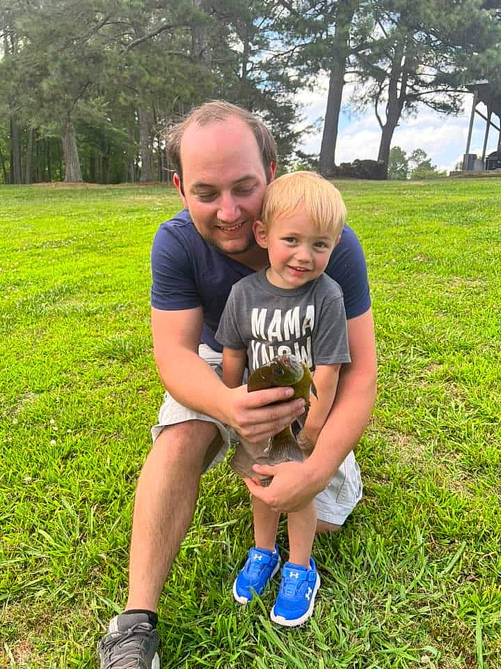 Graeson is registered to the contest to win money with this photo: botany, fun, grass, grassland, happy, joy, lawn, leaf, leisure, mammal, meadow, people, people_in_nature, person, plant, recreation, shoe, shorts, smile, sneakers