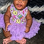Jemma joined the competition — help win amazing prizes! baby, blanket, child, clothing, couch, cute, face, feet, hand, happy, headband, ice_cream_pattern, indoors, infant, portrait, purple, sitting, smiling, teddy_bear_pattern, tutu