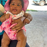 Jemma joined the competition — help win amazing prizes! baby, car, child, clothing, concrete, cute, feet, hand, happy, holding, infant, legs, nature, outdoor, person, pink_hat, smiling, sunlight, trees, watermelon_pattern