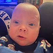 Junior joined the competition — help win amazing prizes! baby, blue_eyes, child, closeup, clothing, curious_expression, cute, face, head, home, indoor, infant, navy_blue, person, portrait, sitting, skin, snowman_print, soft_lighting, young