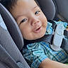 toddler, child, car_seat, safety_harness, plaid_shirt, smile, happy, baby, face, seatbelt, car_interior, headrest, child_safety, infant, cute, portrait, young_child, clothing, plush_toy, seat