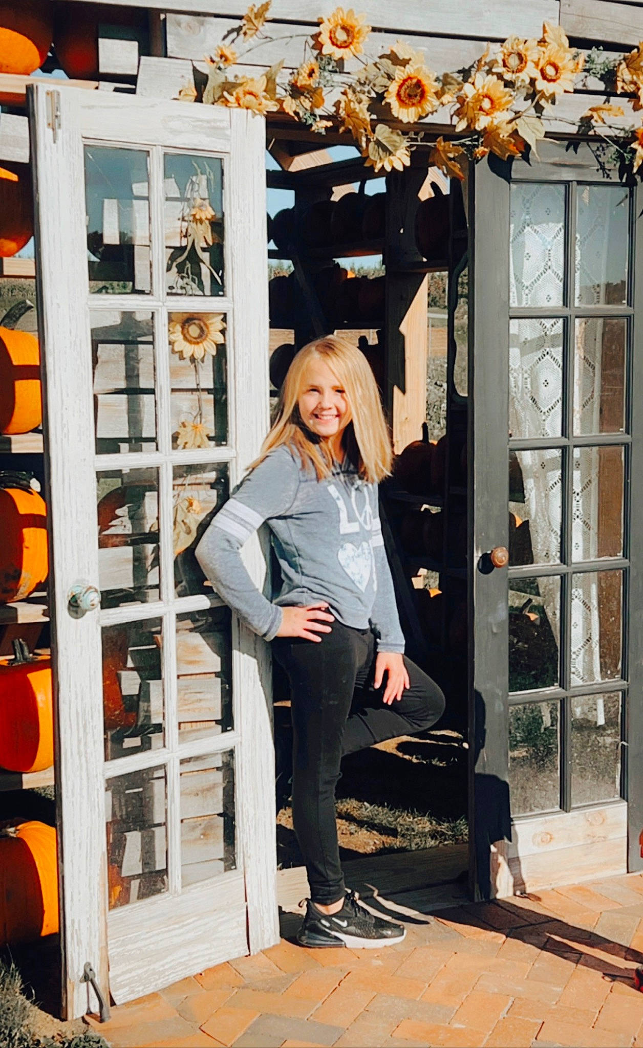 Catherine is registered to the contest to win money with this photo: bag, beauty, boot, door, eyewear, fashion, fashion_design, human_leg, joy, luggage_and_bags, orange, person, room, shoe, sleeve, smile, sportswear, standing, sunglasses, t_shirt