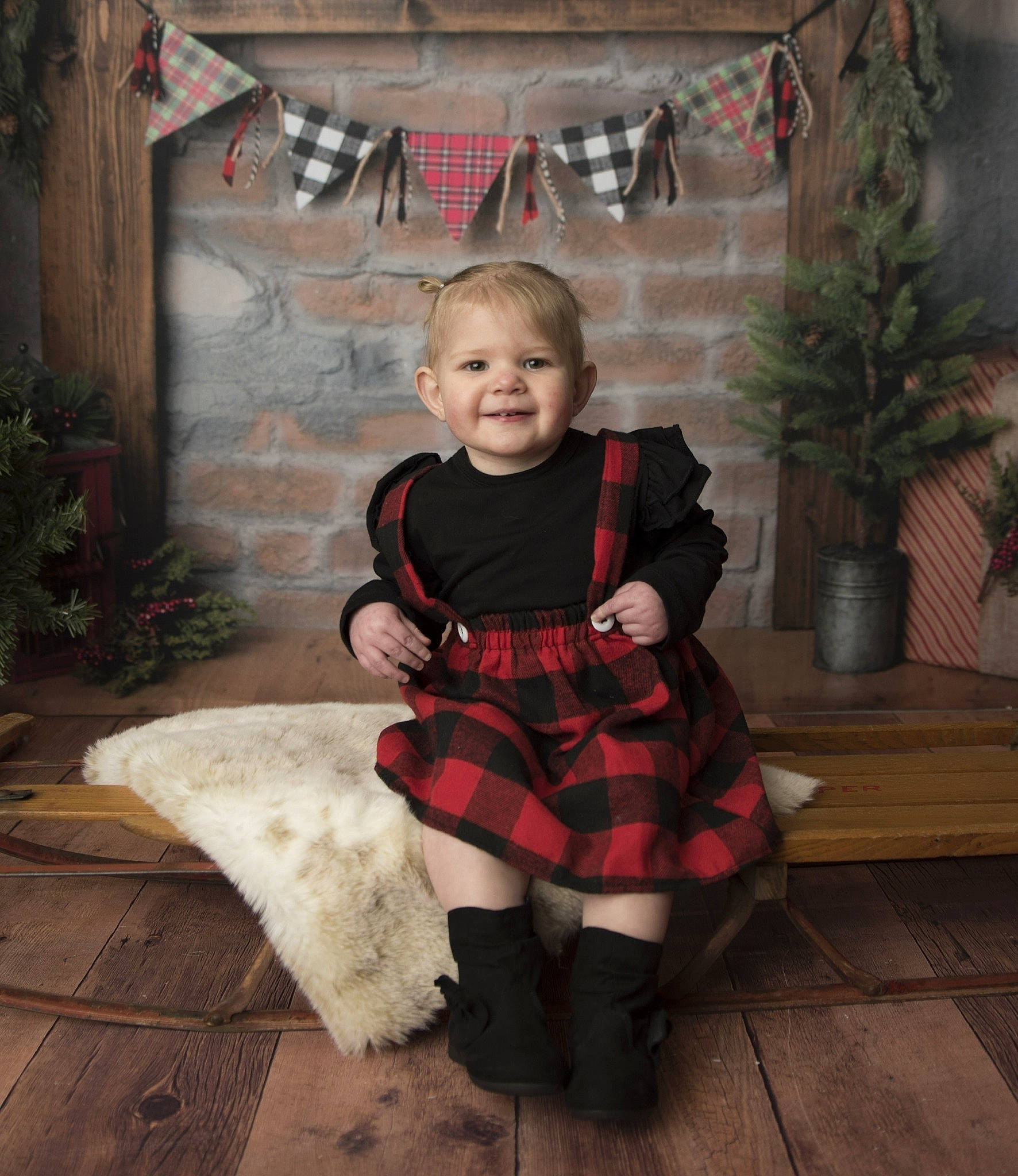 Kira Snow is registered to the contest to win money with this photo: child, christmas, design, joy, kilt, pattern, person, plaid, sitting, smile, tartan, textile, toddler