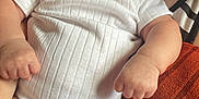 Zariah is registered to the contest to win money with this photo: baby, infant, white_onesie, chubby, curious, indoor, couch, hand, furniture, skin, head, face, person, child, young, cute, plush, soft, comfort, heart_sticker