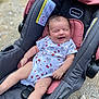 baby, car_seat, infant, smiling, hello_kitty, onesie, clothing, outdoor, happy, child, seat, pink, black, person, cute, infancy, baby_girl, legs, face, small_child