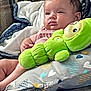 Zariah is registered to the contest to win money with this photo: baby, plush_toy, couch, blanket, pillow, infant, child, face, relaxing, indoors, soft_toy, patterned_fabric, comfort, seated, cute, young_child, home, cozy, resting, casual