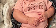 Zariah is registered to the contest to win money with this photo: baby, blanket, chubby_arms, chubby_legs, cozy, cute, face, happy, indoors, infant, lying_down, onesie, person, pink_clothing, relaxed, skin, smiling, soft_texture, tongue_out, young_child