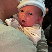 Kelani-Ella is registered to the contest to win money with this photo: adult, affection, baby, blanket, closeup, clothing, cute, expression, face, family, hat, headwear, holding, hug, indoor, kiss, love, person, skin, warmth