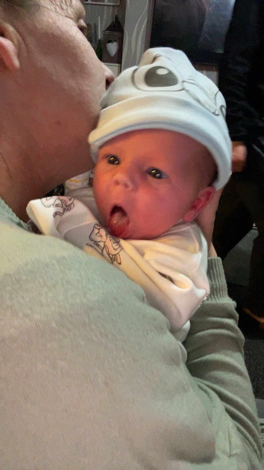 Kelani-Ella is registered to the contest to win money with this photo: adult, affection, baby, blanket, closeup, clothing, cute, expression, face, family, hat, headwear, holding, hug, indoor, kiss, love, person, skin, warmth