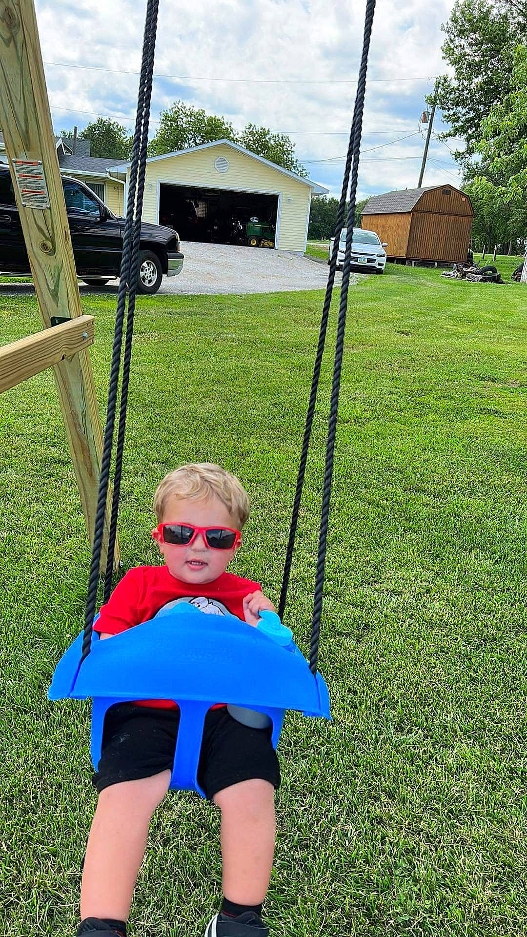 Brysen joined the competition — help win amazing prizes! baby_toddler_clothing, car, cloud, electric_blue, fun, grass, grassland, lawn, leisure, natural_environment, people_in_nature, person, plant, recreation, shorts, sky, summer, sunglasses, toddler, tree