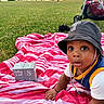 baby, blanket, blocks, bucket_hat, child, crawling, curious, grass, hat, lake, mountain, nature, numbers, outdoor, park, person, picnic, striped_blanket, stroller, sunset