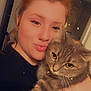 Squeeken Marie joined the competition — help win amazing prizes! affection, black_shirt, cat, close_up, cozy, eyelashes, face, furry, hair_bun, hand, holding, indoor, person, pet, red_hair, ring, selfie, stars, tabby_cat, warm_lighting