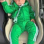 baby, child, car_seat, green_tracksuit, adidas, nike_shoes, sneakers, pacifier, indoor, seat, child_clothing, footwear, person, infant, young_child, casual_wear, cute, portrait, serious_expression, car_interior