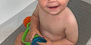 Isaac participe au concours pour gagner de l'argent avec cette photo : baby, bathtub, bath, child, smile, toy, water, skin, play, happy, sitting, curly_hair, young_child, indoor, bath_mat, person, cute, toddler, fun, bath_time