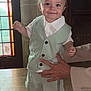 Isaac a rejoint le concours — aidez-le/la à gagner de superbes lots ! toddler, child, smiling, vest, shorts, white_shirt, sandals, socks, hand_support, stained_glass_window, wooden_floor, indoor, portrait, cute, happy, baby, person, fashion, light, background