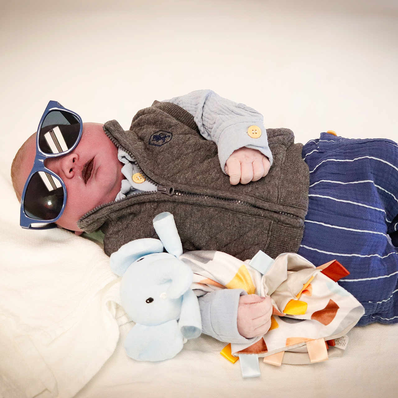 Paxton joined the competition — help win amazing prizes! accessories, baby, blanket, bodypart, cap, clothing, couch, face, finger, furniture, glasses, hand, happy, hat, head, newborn, person, photography, portrait, sunglasses
