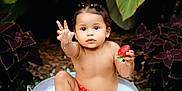 Mya joined the competition — help win amazing prizes! toddler, baby, strawberry, milk_bath, metal_tub, outdoor, green_leaves, wood_chips, nature, child, red_swimwear, cute, sitting, curious, playful, summer, fresh_fruit, portrait, garden, water