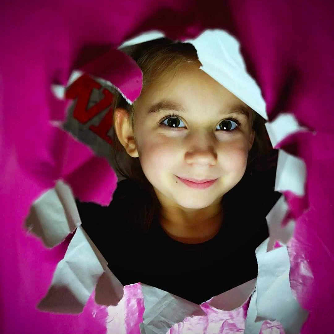 Arianna is registered to the contest to win money with this photo: baby, bodypart, cap, clothing, coat, costume, face, happy, hat, head, jacket, mouth, paper, person, photography, portrait, purple, smile, t_shirt, teeth