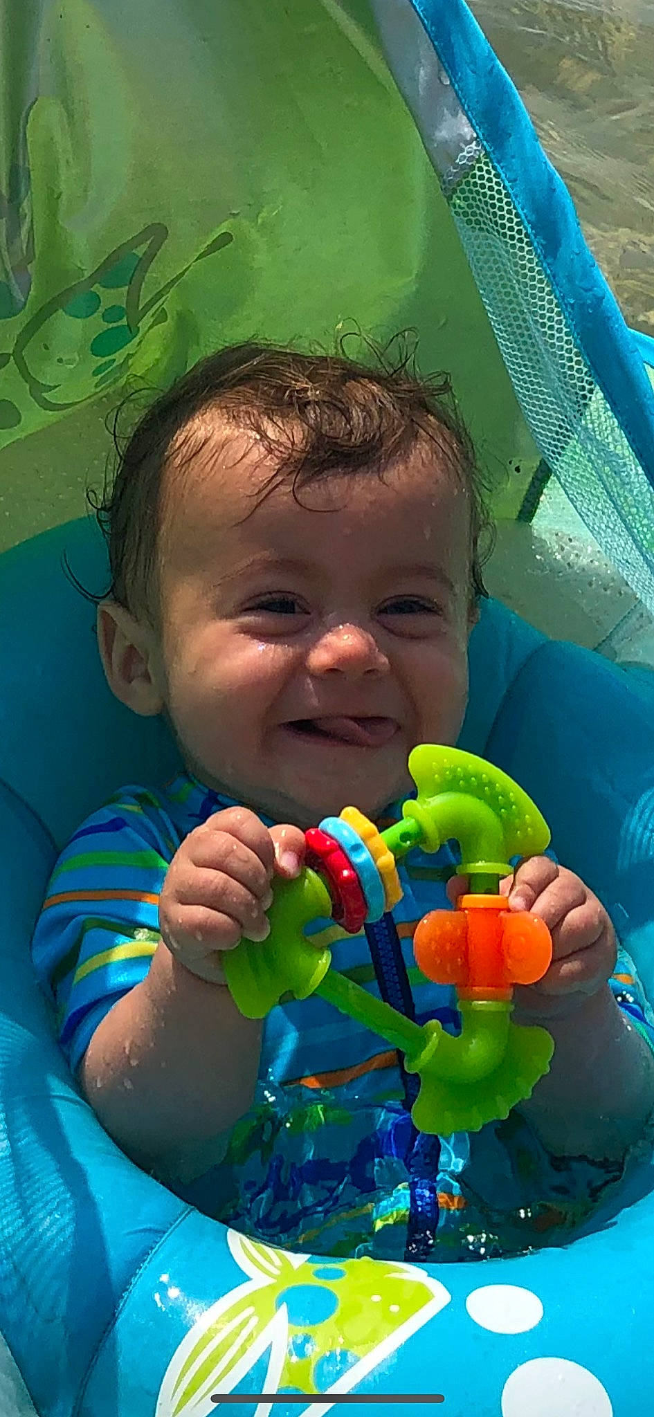 Sam is registered to the contest to win money with this photo: aqua, azure, baby, blue, eye, finger, fun, gesture, grass, green, hand, happy, nose, organ, person, photograph, product, smile, toddler, toy