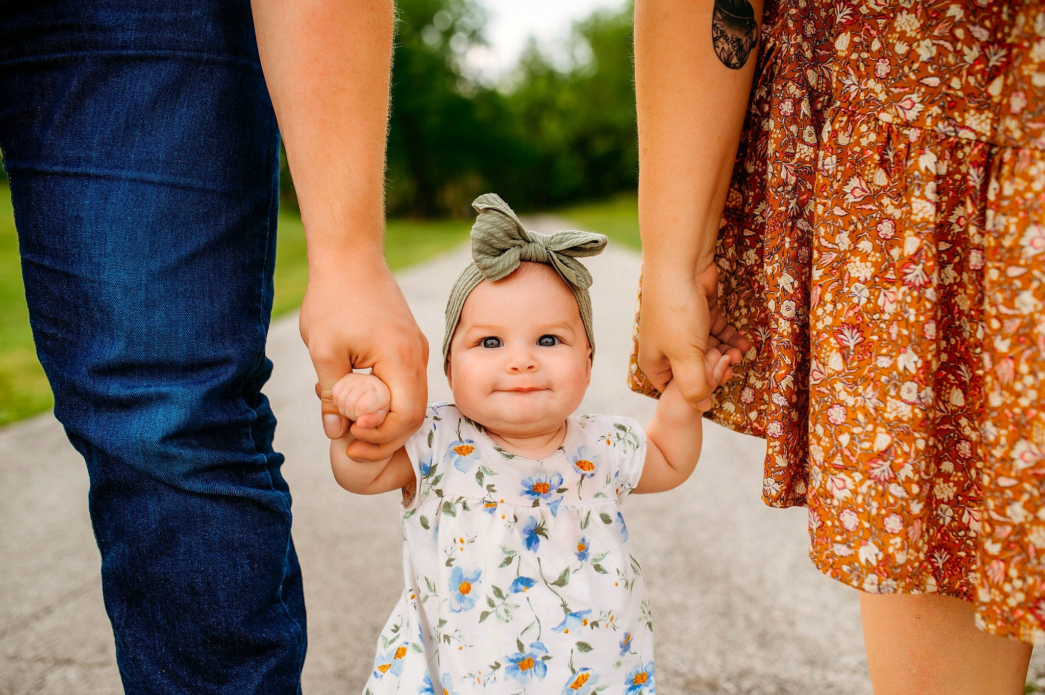 Maeve is registered to the contest to win money with this photo: baby, baby_toddler_clothing, child, dress, facial_expression, fashion, finger, fun, gesture, grass, hand, happy, interaction, jewellery, joy, orange, people_in_nature, person, toddler, tree