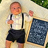 Apollo joined the competition — help win amazing prizes! baby, infant, grass, blanket, sign, chalkboard, text, flowers, daisies, outdoor, nature, clothing, bow_tie, suspenders, celebration, holiday, cute, portrait, smile, child