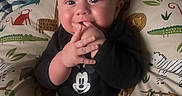 Apollo joined the competition — help win amazing prizes! baby, infant, child, mickey_mouse, black_clothing, pillow, animal_print, cute, smiling, hand_in_mouth, indoor, cozy, face, head, person, portrait, young, adorable, playful, comfort