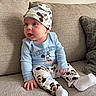 baby, child, clothing, comfortable, couch, cute, expression, hat, home, indoors, infant, mickey_mouse, person, pillow, portrait, seated, socks, soft_lighting, texture, tongue_out