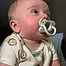 Apollo joined the competition — help win amazing prizes! baby, pacifier, infant, onesie, side_profile, cute, child, face, skin, expression, curious, indoors, portrait, young, small, human, childhood, clothing, sleeve, head