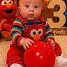 baby, balloon, birthday, carpet, celebration, child, colorful_clothing, cute, elmo, happy, indoor, infant, number_three, portrait, red_balloon, smiling_toy, striped_shirt, stuffed_toy, white_shoes, wooden_number