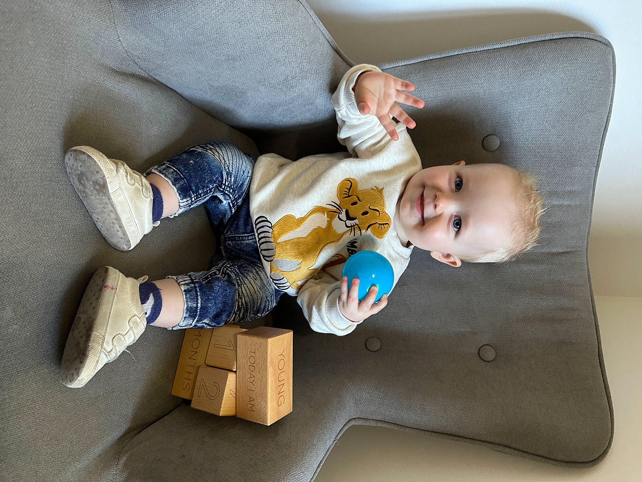 Archie joined the competition — help win amazing prizes! baby, baby_products, baby_sleeping, baby_toddler_clothing, chair, child, comfort, couch, happy, human_leg, joy, lap, linens, person, room, sitting, smile, sock, toddler, wood