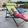 Agathe a rejoint le concours — aidez-le/la à gagner de superbes lots ! barefoot, casual_clothing, child, concrete_floor, curly_hair, daylight, deck_chair, glasses, green_chair, happy, inflatable_pool, outdoor, patio, pink_pants, potted_plants, recreation, relaxed, smiling, teddy_bear, toy