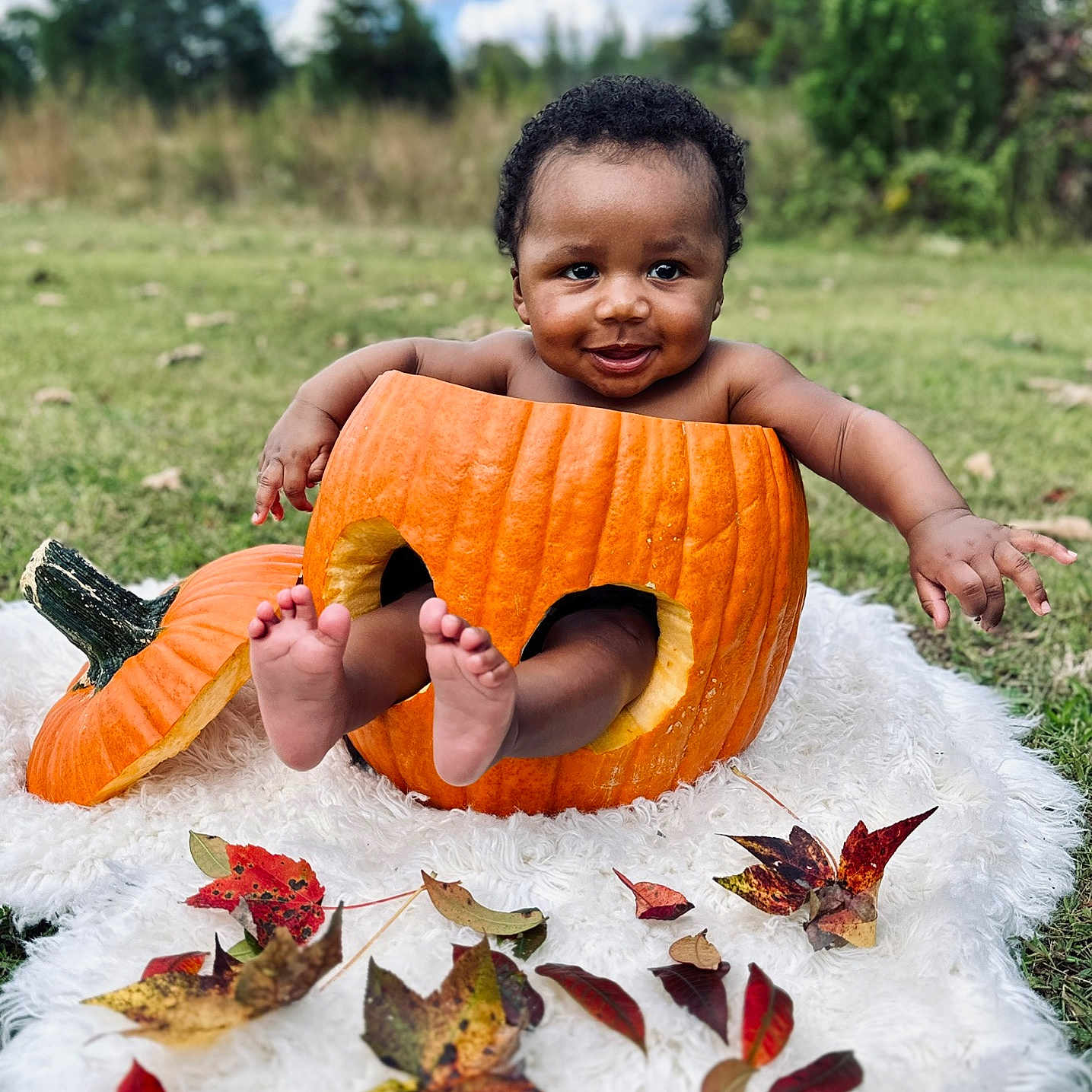 Jahaad is registered to the contest to win money with this photo: autumn_leaves, baby, blanket, child, cute, fall, feet, grass, greenery, hands, happy, nature, outdoor, playful, portrait, pumpkin, seasonal, skin, sky, smiling