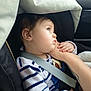 toddler, child, car_seat, seatbelt, striped_clothing, hand, arm, tattoo, window, car_interior, baby, side_view, cute, safety, restraint, curious, clothing, portrait, indoor, child_safety