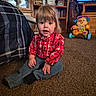Caroline joined the competition — help win amazing prizes! child, toddler, portrait, sitting, carpet, indoors, red_shirt, plaid, jeans, blonde_hair, blue_eyes, smiling, toy, toy_walker, bookshelf, books, television, living_room, furniture, family_home