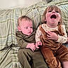 children, siblings, baby, toddler, laughing, smiling, portrait, bed, bedroom, blanket, plaid, clothing, overalls, corduroy, infant, family, sitting, indoor, happy, playful