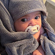 Amoura joined the competition — help win amazing prizes! baby, pacifier, towel, hood, cute, wrapped, infant, face, hand, soft, grey, plush, cozy, indoors, expression, closeup, child, newborn, warm, comfort