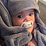 baby, pacifier, towel, hood, cute, wrapped, infant, face, hand, soft, grey, plush, cozy, indoors, expression, closeup, child, newborn, warm, comfort
