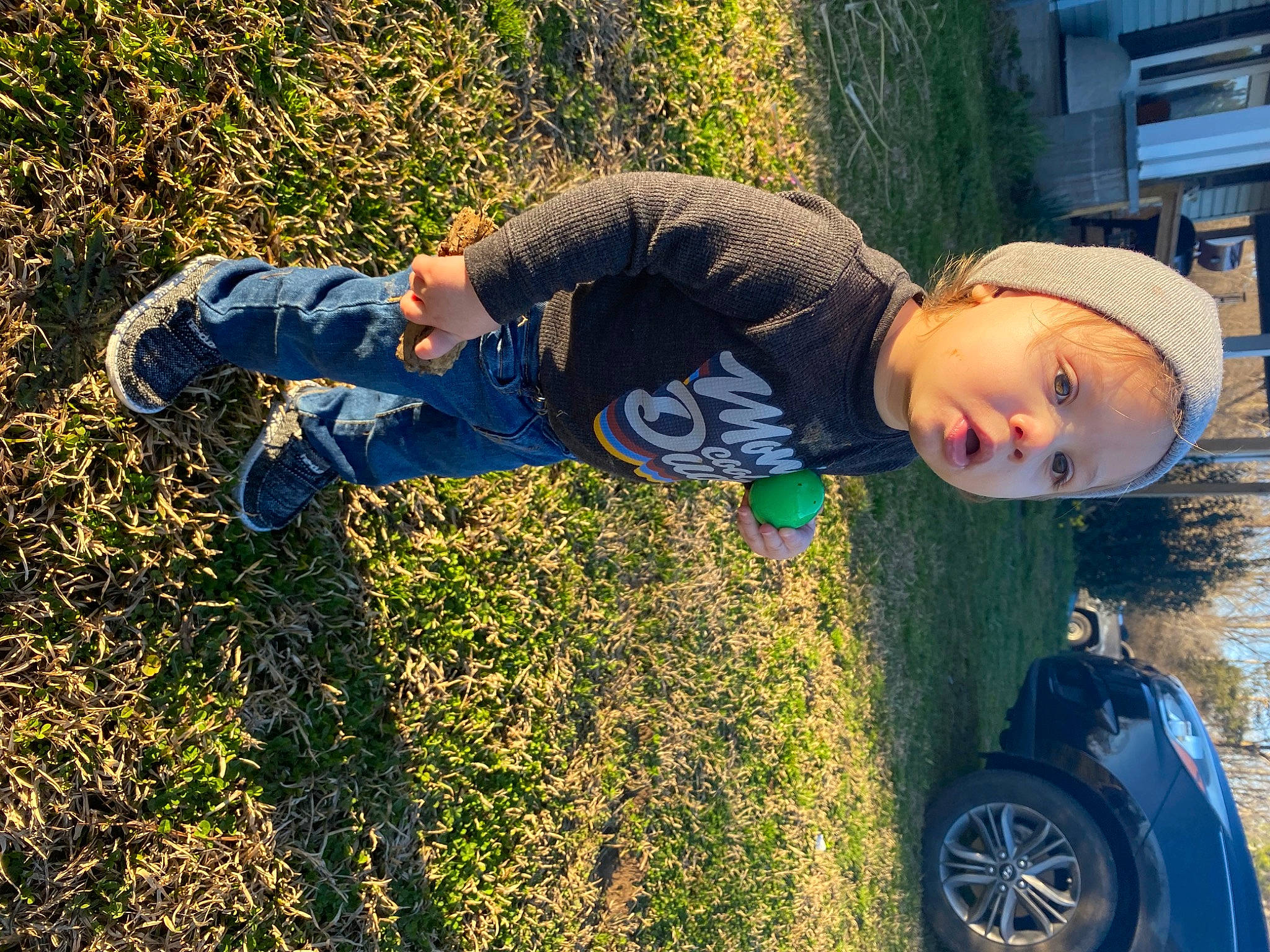 Cyrus is registered to the contest to win money with this photo: automotive_tire, blue, car, cool, electric_blue, grass, happy, hat, leisure, people_in_nature, person, plant, sneakers, sunlight, t_shirt, tire, toddler, tree, vehicle, vehicle_door