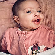 Aïda participe au concours pour gagner de l'argent avec cette photo : baby, infant, smiling, pink, blanket, onesie, minnie_mouse, cartoon, face, eyes, ear, cheek, mouth, tongue, bedding, portrait, indoor, cute, newborn, clothing
