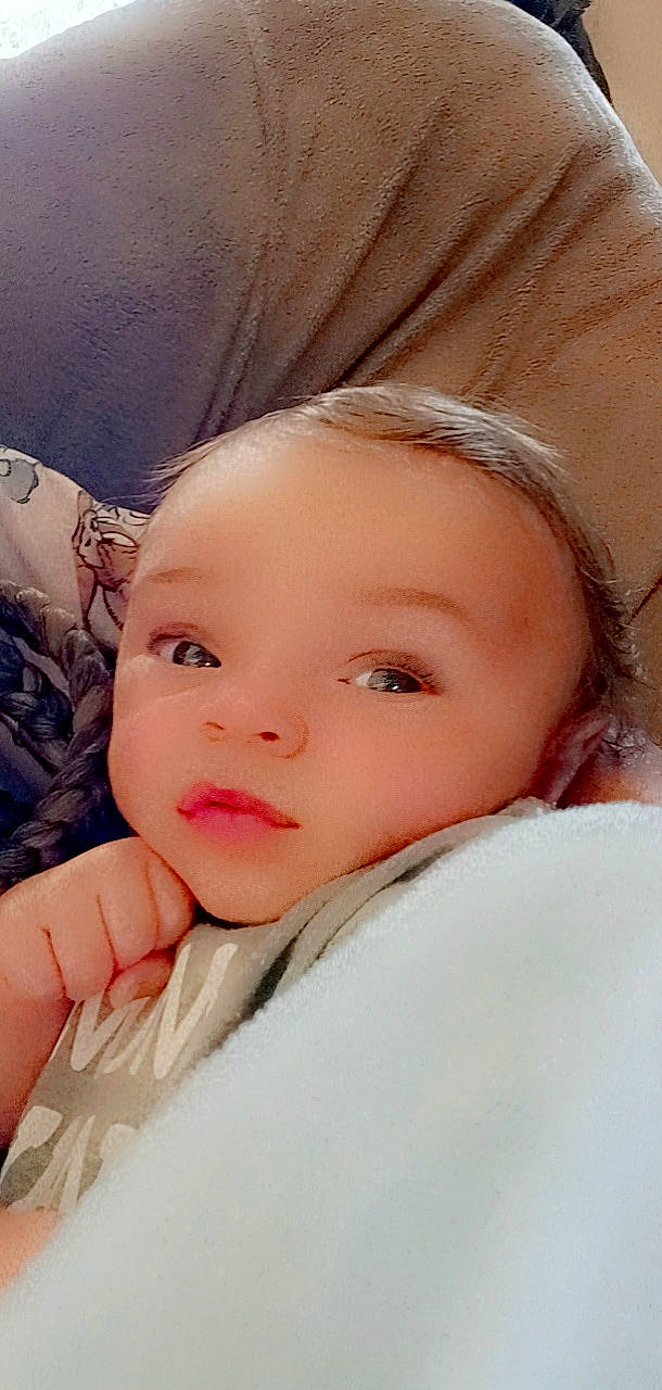 Elijah M Jackson is registered to the contest to win money with this photo: brown_hair, cheek, child, comfort, eye, eyebrow, eyelash, flash_photography, fur, happy, iris, linens, lip, nose, person, pink, skin, sleeve, smile, textile