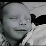baby, newborn, sleeping, smile, close_up, blanket, pacifier_chain, soft_lighting, portrait, monochrome, skin, face, peaceful, infant, cheek, nose, eyelids, cuddly, cozy, nap