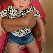 Bug joined the competition — help win amazing prizes! baby, child, person, adult, holding, indoor, headband, bow, clothing, denim_shorts, cute, portrait, expression, face, hand, skin, blue_eyes, standing, woman, casual