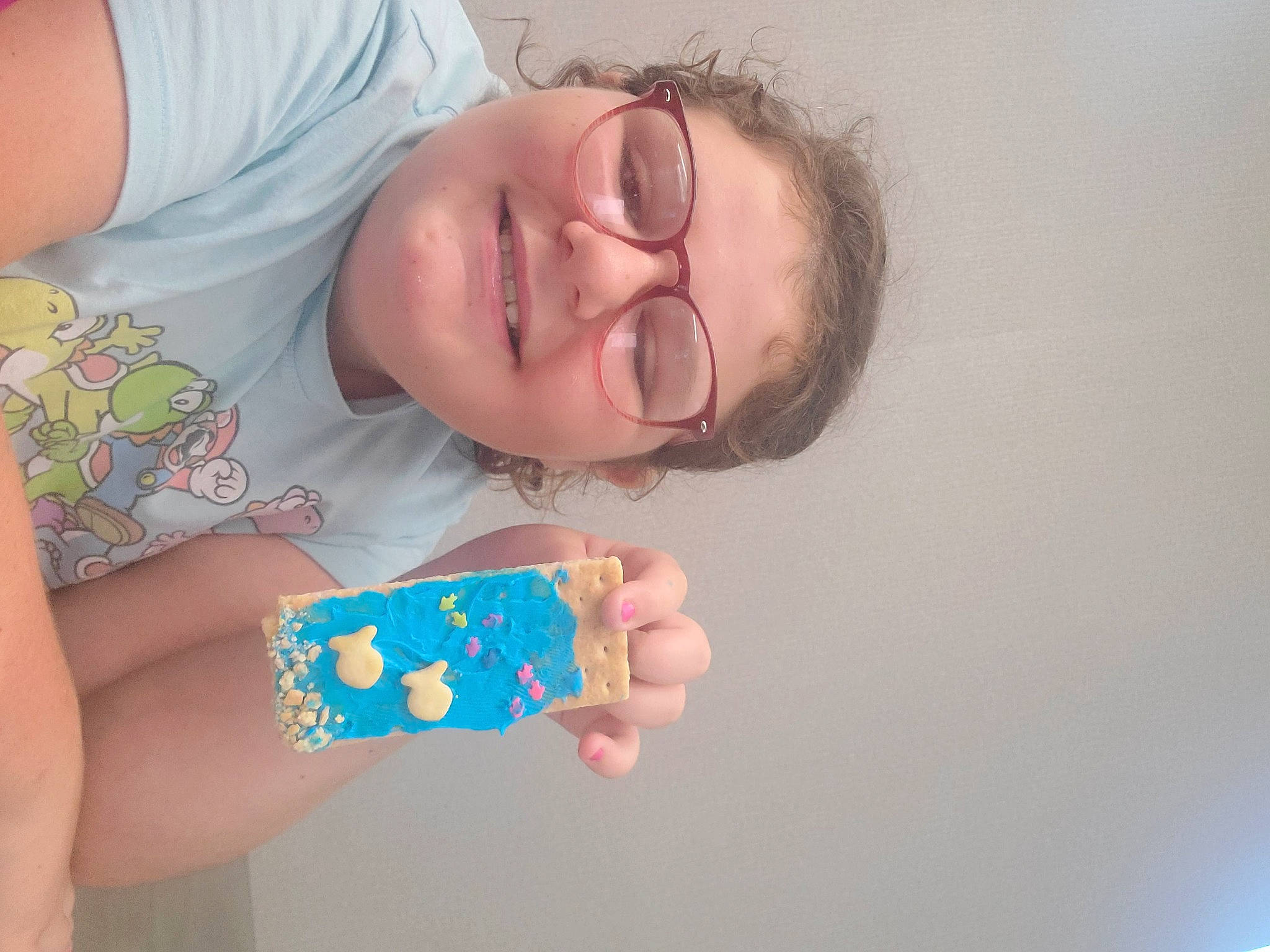 Emma is registered to the contest to win money with this photo: baby, child, elbow, eyewear, finger, fun, gesture, glasses, happy, joy, lip, mouth, nail, neck, nose, pattern, person, skin, sleeve, smile
