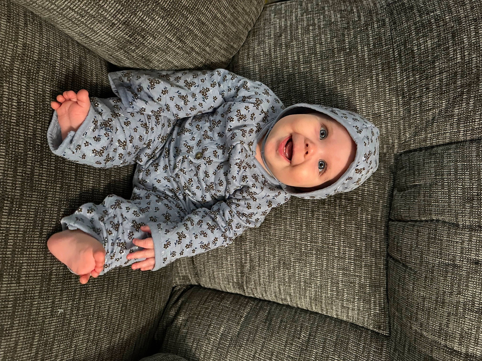 Adalynn is registered to the contest to win money with this photo: baby_toddler_clothing, beauty, comfort, facial_expression, grey, headwear, human, human_leg, joy, knee, linens, mammal, military_camouflage, outerwear, pattern, person, sitting, sleeve, smile, textile