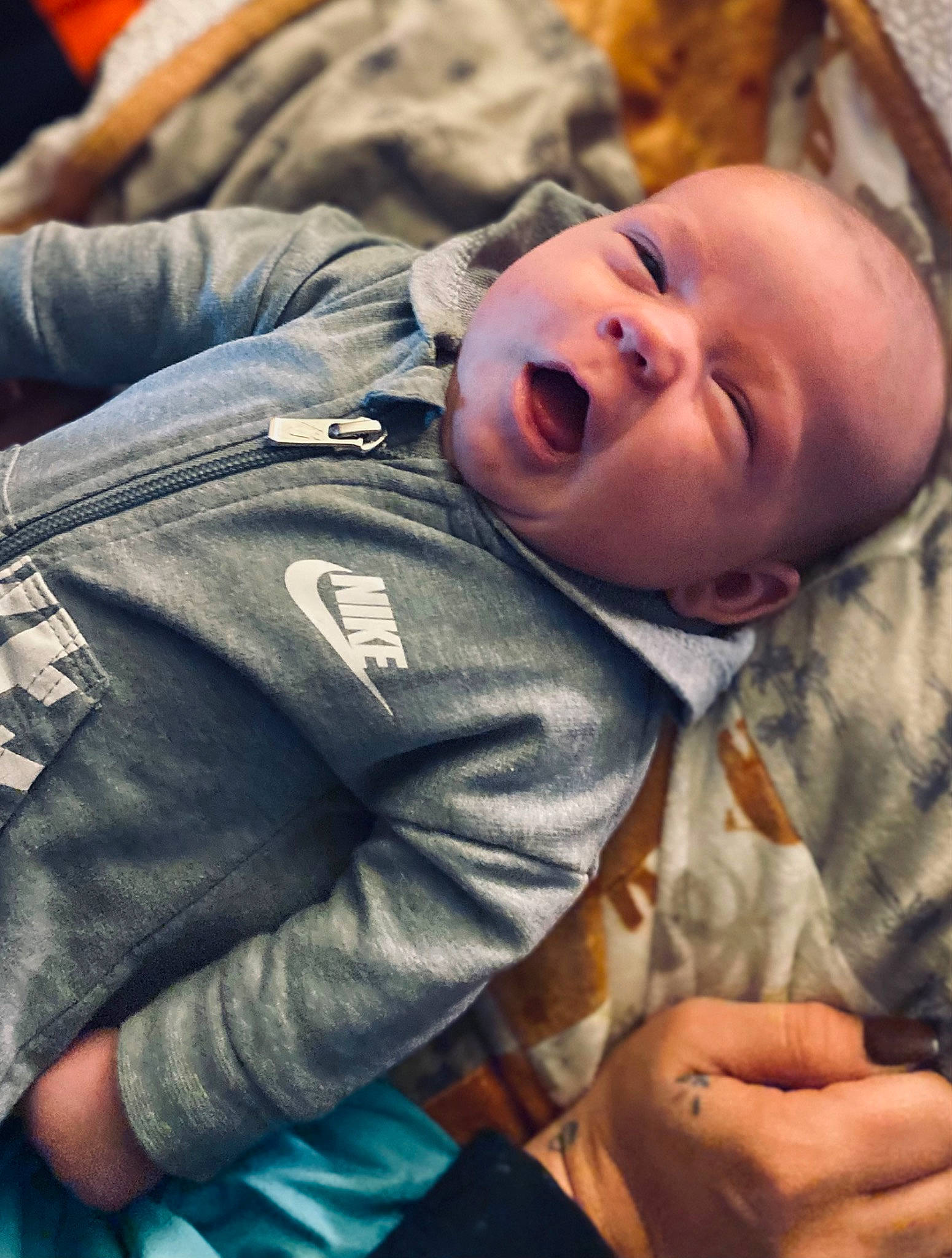 Zaydon is registered to the contest to win money with this photo: baby, baby_toddler_clothing, cheek, child, comfort, finger, fun, gesture, grass, happy, laugh, person, portrait_photography, sitting, sleep, smile, thumb, toddler, tree, wood