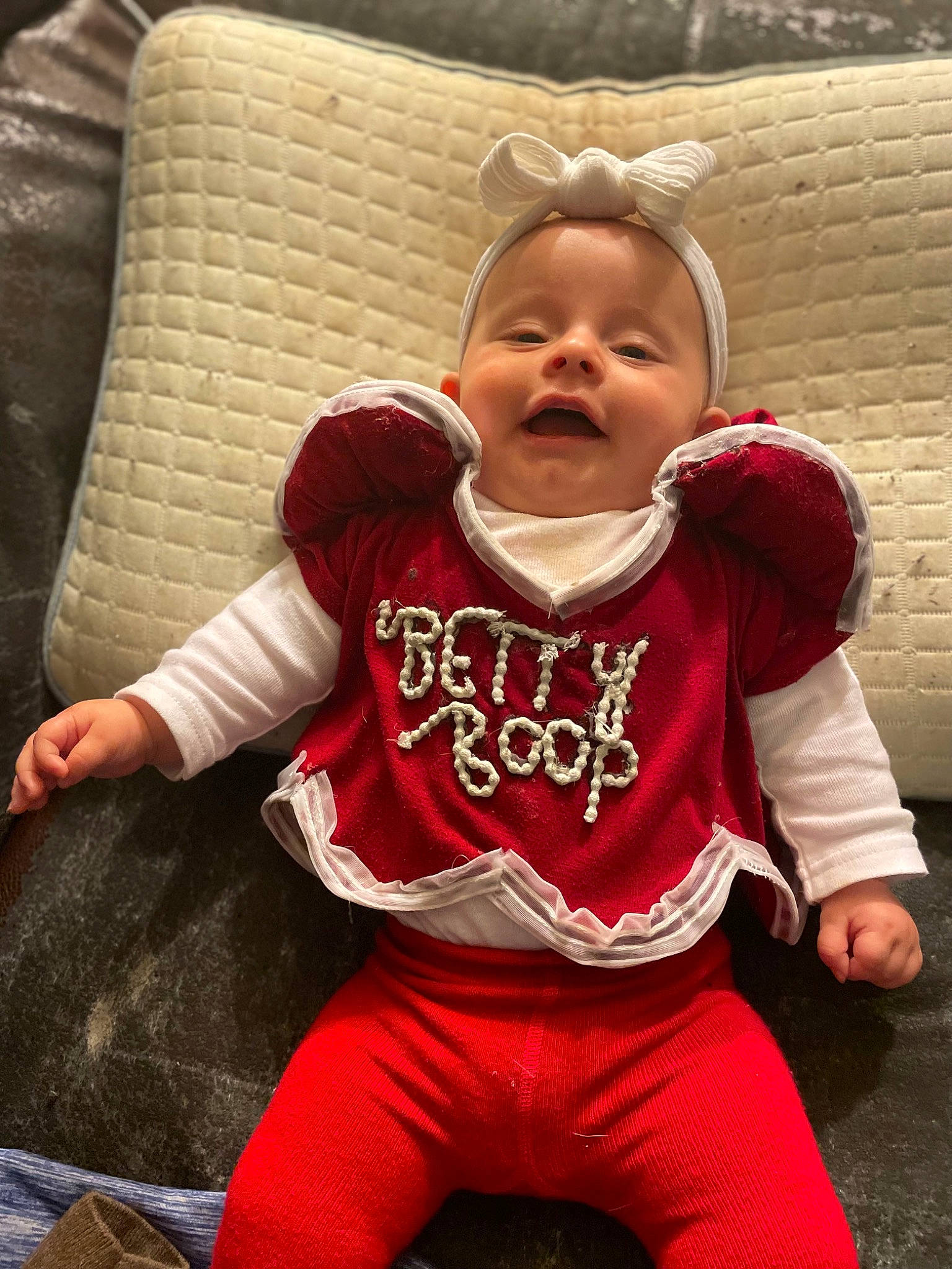 Betty is registered to the contest to win money with this photo: baby, baby_toddler_clothing, cheek, child, chin, comfort, cool, face, fun, happy, head, human_body, mouth, outerwear, person, skin, sleeve, smile, t_shirt, toddler